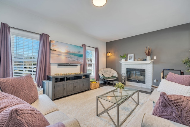 carpeted living room featuring a fireplace