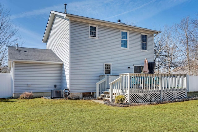 back of property with a yard, central AC, a wooden deck, and fence