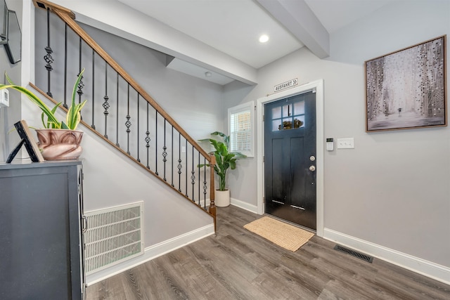 entryway featuring stairs, wood finished floors, visible vents, and baseboards