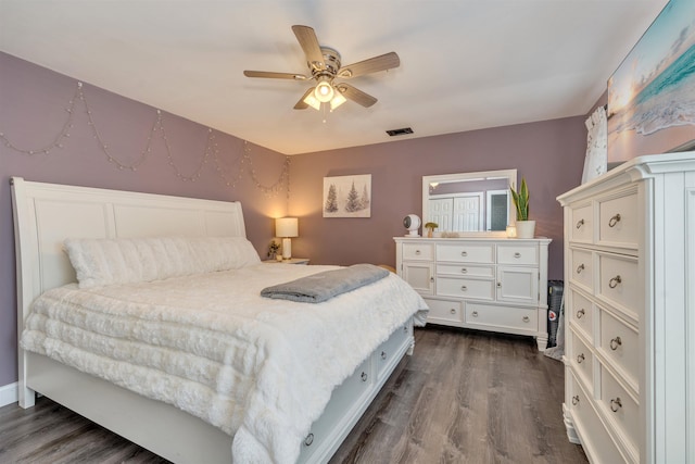 bedroom featuring dark wood-style flooring, visible vents, and ceiling fan