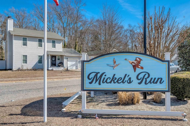 community / neighborhood sign with an attached garage