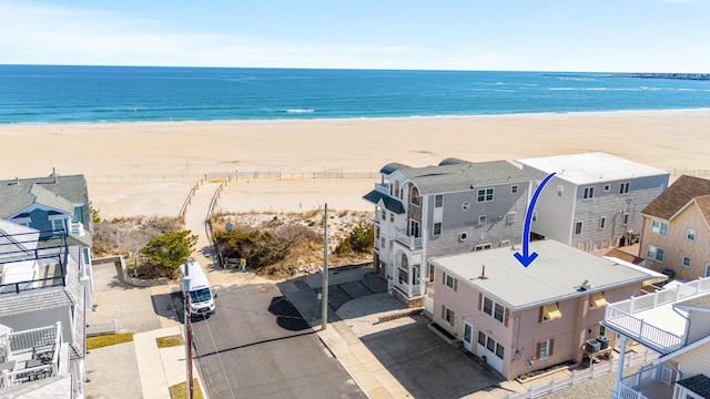 drone / aerial view featuring a water view and a view of the beach