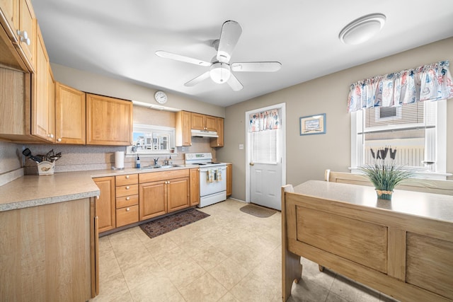 28 89th St, Sea Isle City, NJ 08243 - kitchen with under cabinet range hood, a sink, white range with electric stovetop, light countertops, and ceiling fan