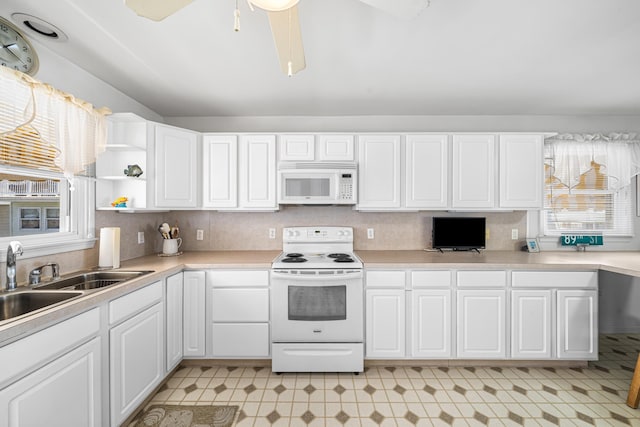 28 89th St, Sea Isle City, NJ 08243 - kitchen with white appliances, white cabinetry, light countertops, and a sink