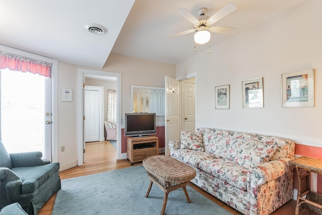 living room featuring ceiling fan and wood-type flooring