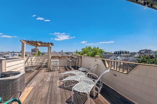 wooden deck featuring a pergola and central AC