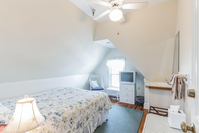 bedroom featuring ceiling fan, dark hardwood / wood-style flooring, and vaulted ceiling