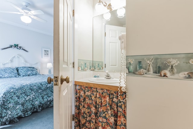 bathroom featuring vanity, ceiling fan, and crown molding