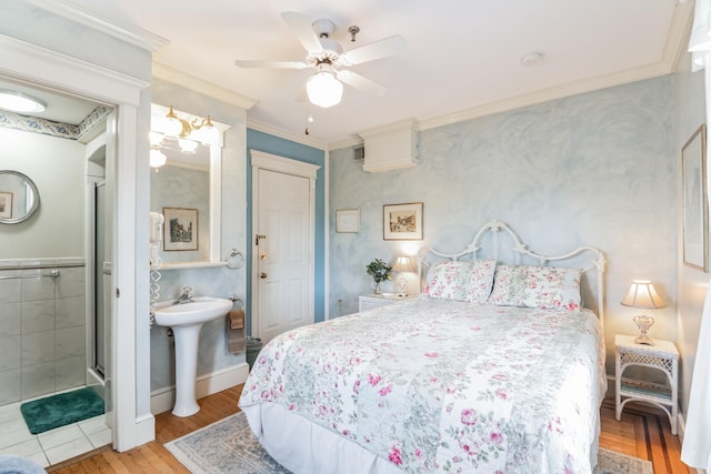 bedroom featuring ceiling fan, sink, ensuite bathroom, light hardwood / wood-style floors, and ornamental molding