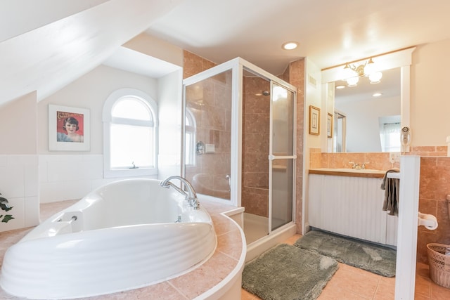 bathroom with tile patterned floors, vanity, and shower with separate bathtub