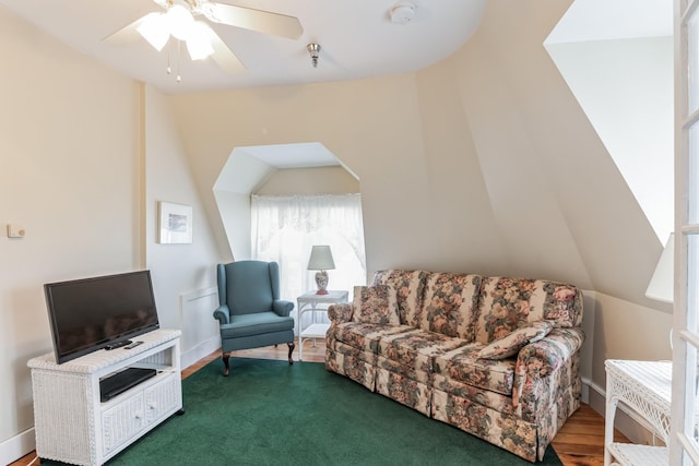 living room featuring ceiling fan and vaulted ceiling