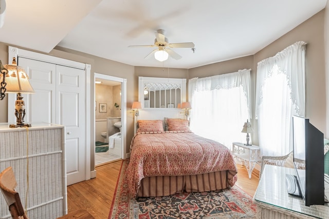 bedroom featuring ceiling fan, wood-type flooring, connected bathroom, and a closet