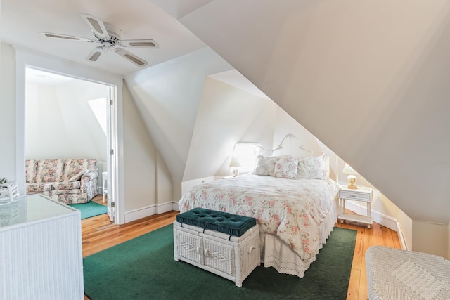 bedroom with hardwood / wood-style floors, ceiling fan, and vaulted ceiling