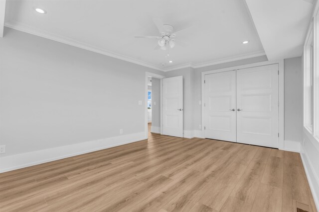 unfurnished bedroom with light wood-style floors, recessed lighting, baseboards, ornamental molding, and a closet