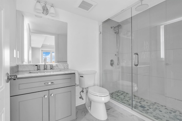 bathroom featuring vanity, toilet, visible vents, and a stall shower