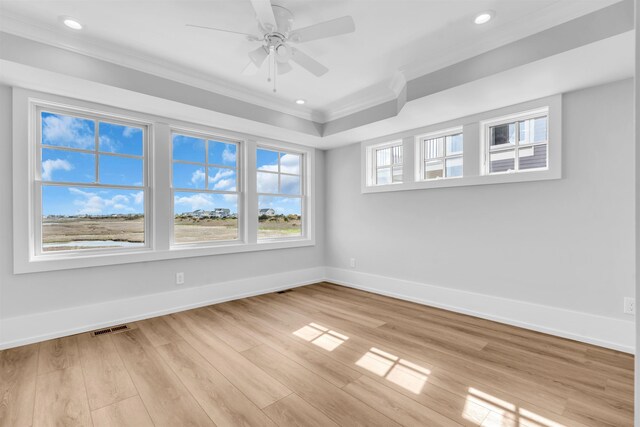 spare room with crown molding, visible vents, baseboards, recessed lighting, and light wood finished floors