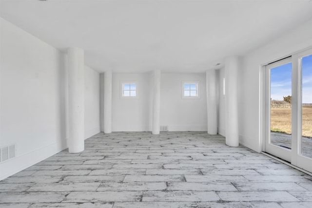 spare room featuring visible vents and wood finished floors