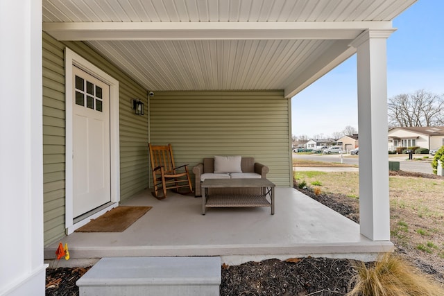 view of patio / terrace with a residential view and a porch
