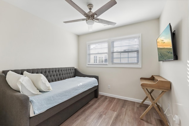 bedroom featuring baseboards, ceiling fan, and wood finished floors