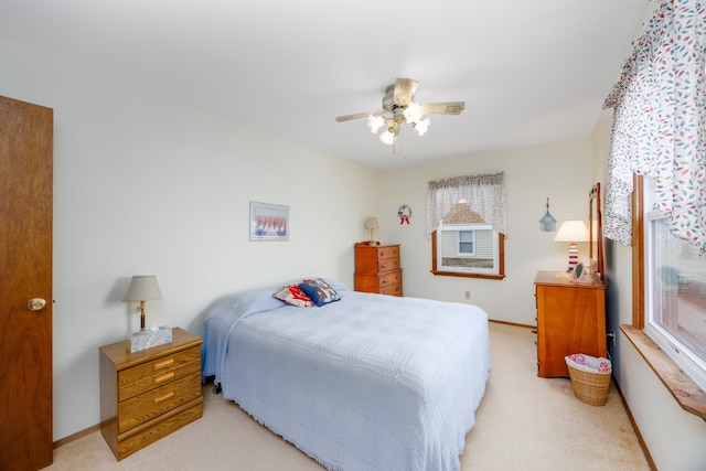 bedroom with light colored carpet and ceiling fan