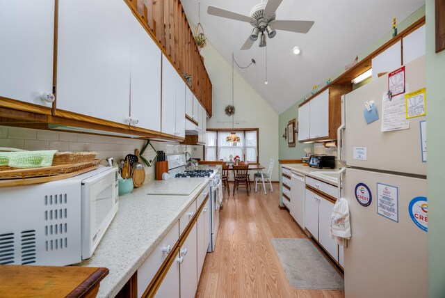 kitchen with white appliances, backsplash, white cabinets, light hardwood / wood-style flooring, and ceiling fan