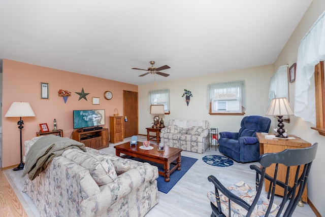 living room featuring ceiling fan and light hardwood / wood-style floors