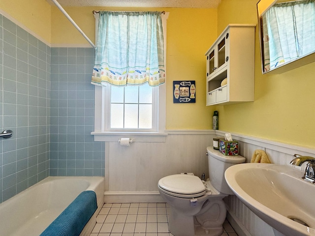 168 98th St, Stone Harbor, NJ 08247 - bathroom with toilet, tile patterned floors, a sink, and a wainscoted wall