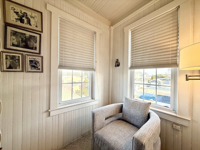 168 98th St, Stone Harbor, NJ 08247 - living area with crown molding, plenty of natural light, wooden walls, and carpet floors