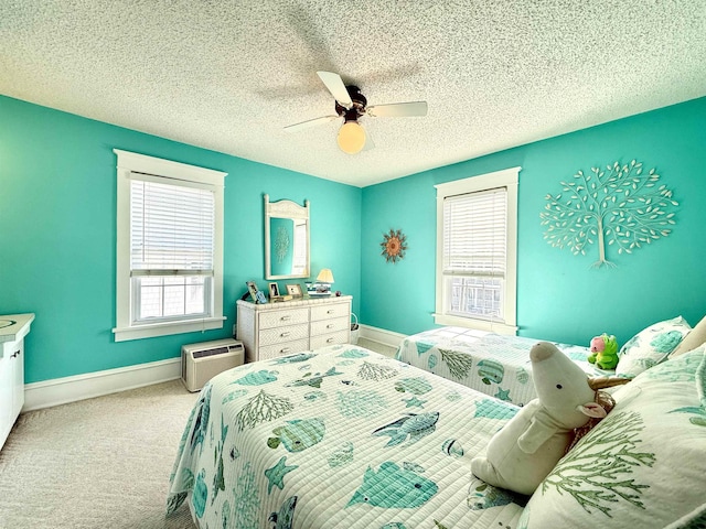 168 98th St, Stone Harbor, NJ 08247 - carpeted bedroom featuring a textured ceiling, baseboards, a ceiling fan, and a wall mounted air conditioner