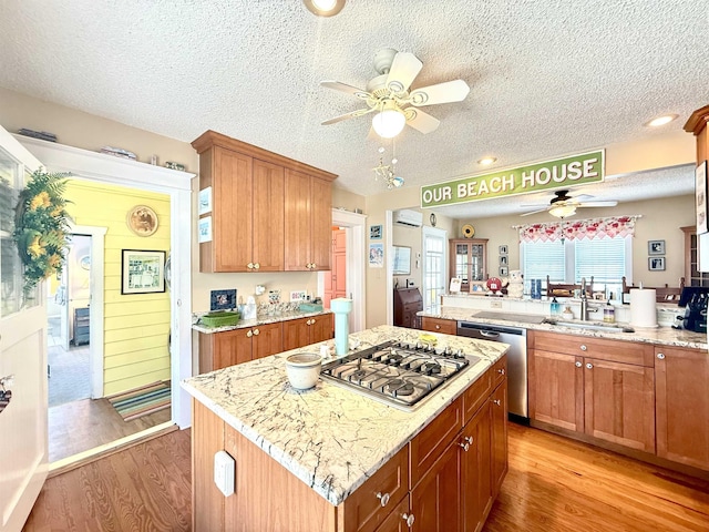 168 98th St, Stone Harbor, NJ 08247 - kitchen featuring ceiling fan, a textured ceiling, appliances with stainless steel finishes, a sink, and light wood finished floors