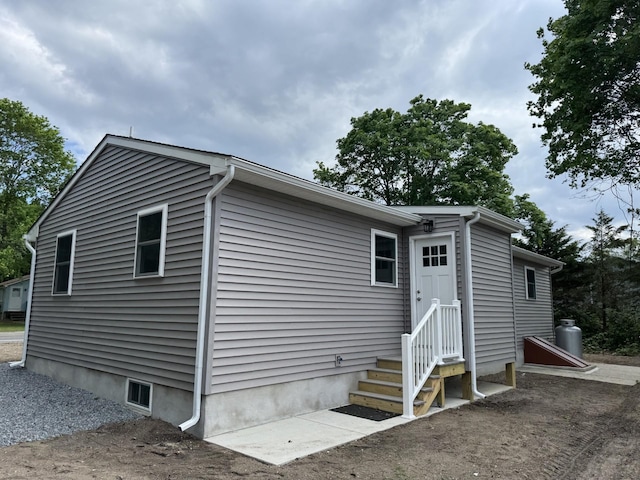 view of side of property featuring entry steps