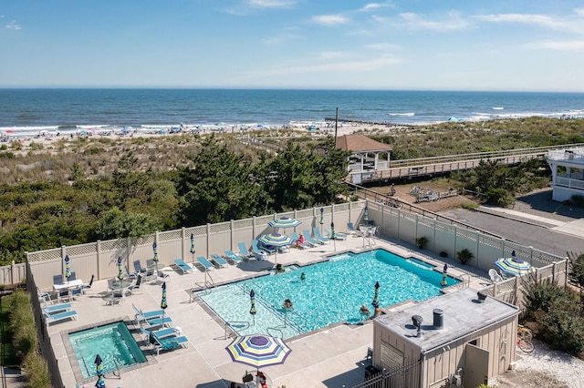 view of pool with a patio and a water view