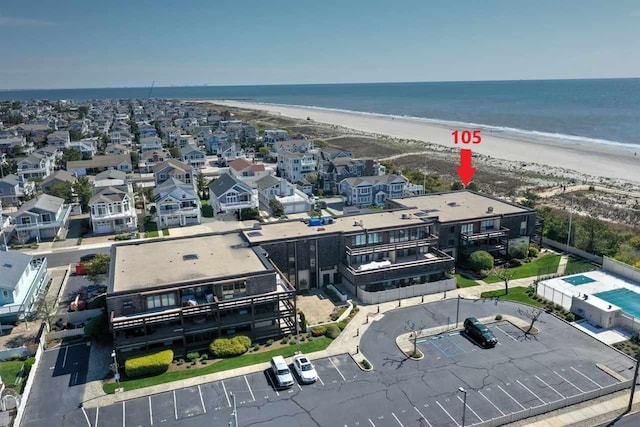 drone / aerial view featuring a water view and a beach view