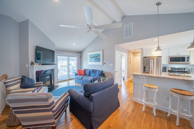 254 89th St Unit 1, Stone Harbor, NJ 08247 - living area featuring beamed ceiling, a glass covered fireplace, light wood finished floors, ceiling fan, and high vaulted ceiling