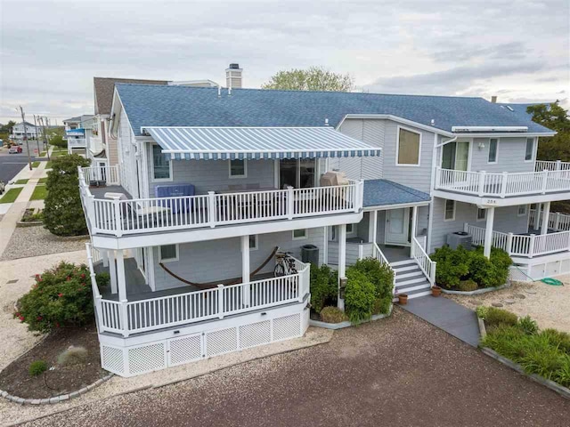 254 89th St Unit 1, Stone Harbor, NJ 08247 - view of front facade featuring a shingled roof and a chimney