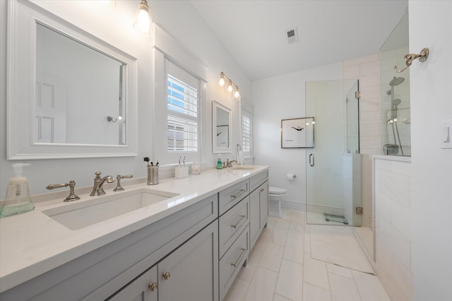 bathroom featuring vanity, toilet, an enclosed shower, and lofted ceiling