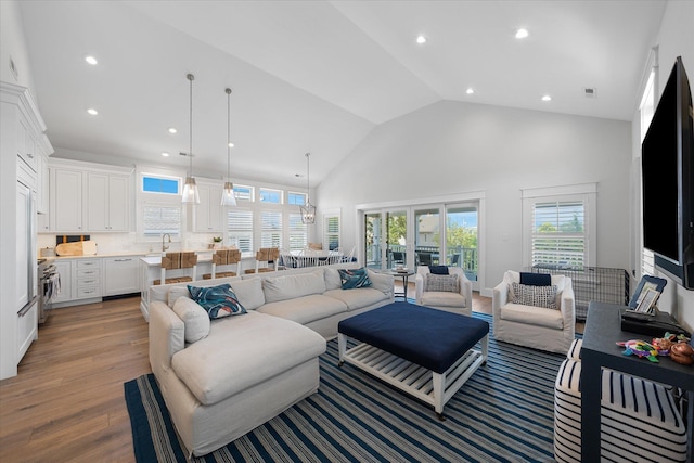 living room with vaulted ceiling and light hardwood / wood-style flooring