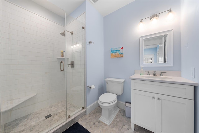 bathroom featuring vanity, toilet, and walk in shower