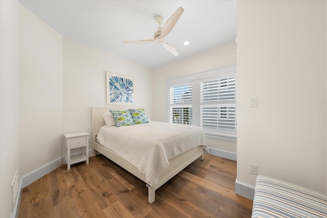 bedroom with ceiling fan and dark wood-type flooring