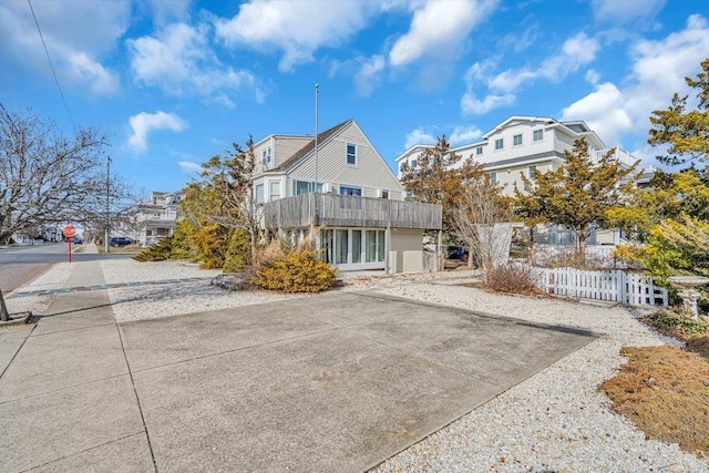 exterior space with a residential view, fence, and a balcony