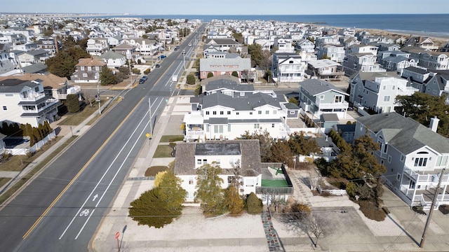 drone / aerial view with a water view and a residential view