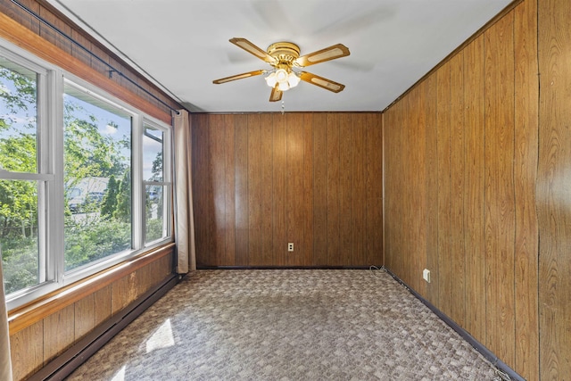 112 Oakdale Ave, Villas, NJ 08251 - unfurnished room featuring wood walls, a baseboard heating unit, and ceiling fan