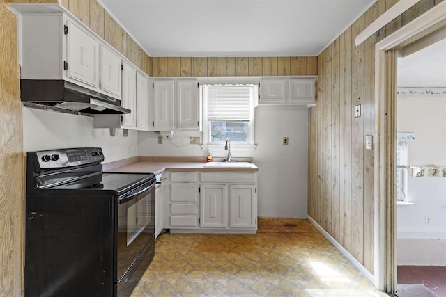 112 Oakdale Ave, Villas, NJ 08251 - kitchen with black electric range oven, light floors, light countertops, white cabinetry, and wood walls