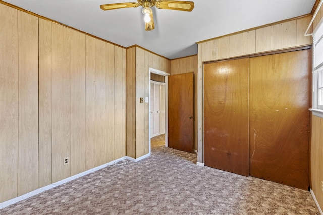 112 Oakdale Ave, Villas, NJ 08251 - unfurnished bedroom featuring carpet, wooden walls, a ceiling fan, and a closet