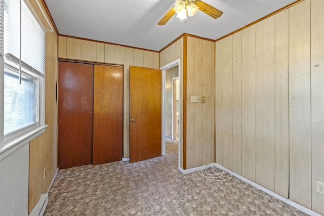 112 Oakdale Ave, Villas, NJ 08251 - unfurnished bedroom featuring wood walls, a closet, carpet flooring, ceiling fan, and ornamental molding