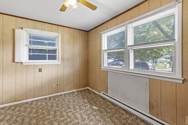 112 Oakdale Ave, Villas, NJ 08251 - spare room with a baseboard radiator, a ceiling fan, wooden walls, and carpet flooring