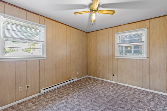 112 Oakdale Ave, Villas, NJ 08251 - carpeted empty room with a baseboard heating unit, a ceiling fan, and wooden walls
