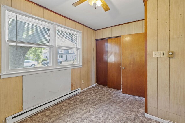 112 Oakdale Ave, Villas, NJ 08251 - carpeted entrance foyer with a baseboard radiator, wood walls, ceiling fan, and crown molding