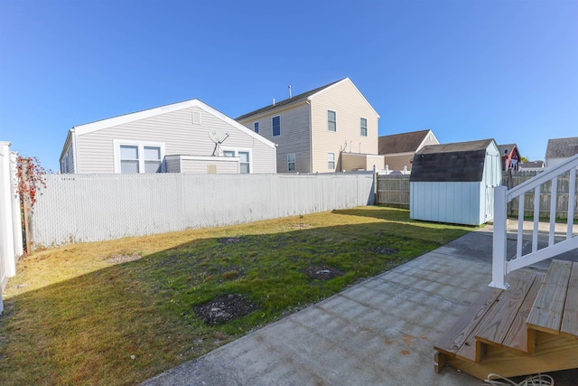 view of yard with a storage unit and a patio area