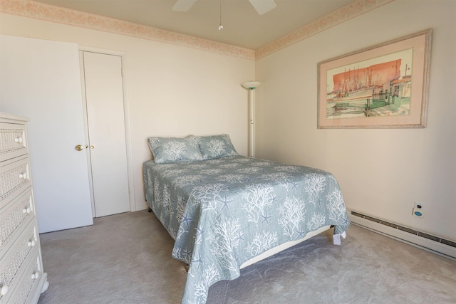 bedroom with ceiling fan, baseboard heating, light carpet, and a closet